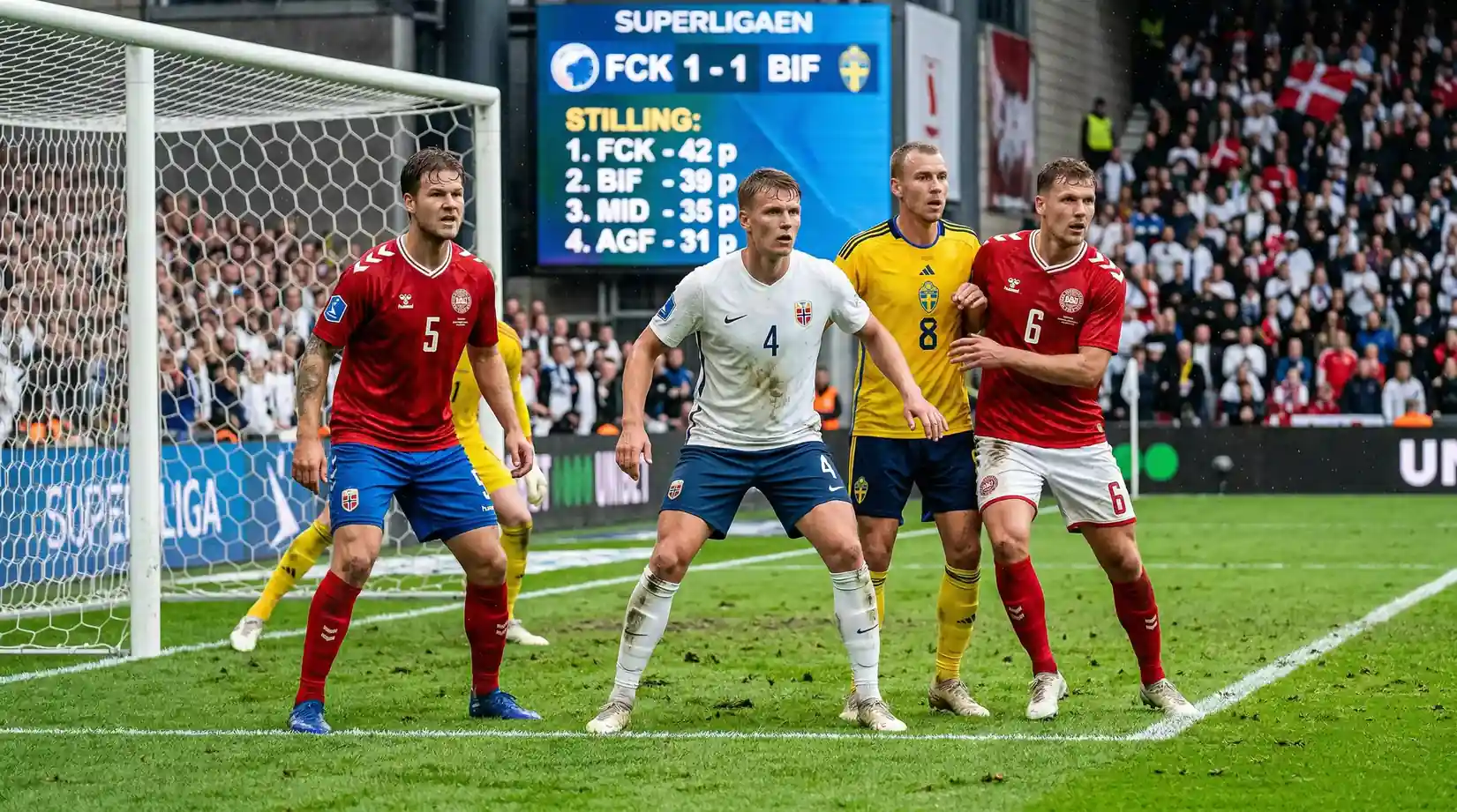 Spillere i forskellige farvede landsholdssæt står tæt i en kampsituation